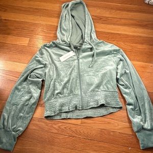 Francesca’s green zip-up